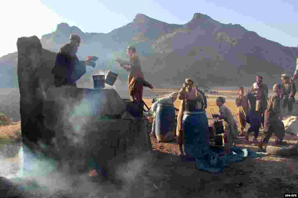 Afghan workers process grapes into raisins in Kandahar. The Kandahar Chamber of Commerce says 10,000 tons of raisins worth $32 million were exported from Kandahar to Pakistan, India, and the U.A.E. last year.