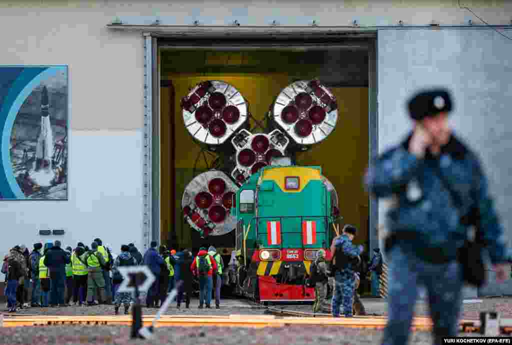 Security personnel keep watch over the Soyuz MS-25 spacecraft as it leaves its assemblage hangar at the Baikonur Cosmodrome in Kazakhstan on March 18. The March 21 launch will send U.S. astronaut Tracy Dyson, Russian cosmonaut Oleg Novitsky, and Belarusian Marina Vasilevskaya to the International Space Station (ISS) aboard the Soyuz spacecraft. &nbsp;