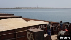 A barge carrying Ukrainian grain is moored for unloading at a port in Romania. (file photo)