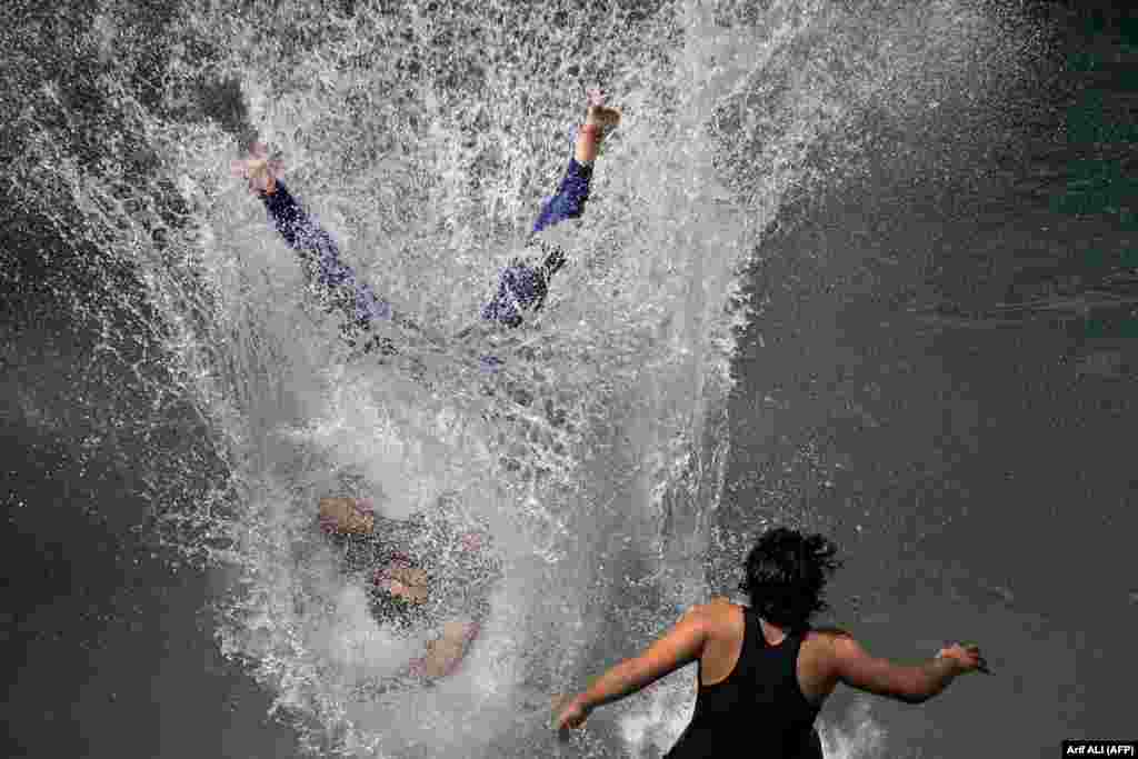 Pakistani&#39;s cool off at a water park in Lahore on May 26 during a heat wave. Authorities in Pakistan&#39;s Punjab Province are advising people to stay indoors as an intense heat wave is expected to last until early June.