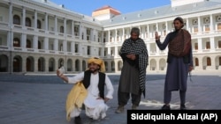 Afghans take selfies at the renovated Darul Aman Palace in the Afghan capital Kabul.