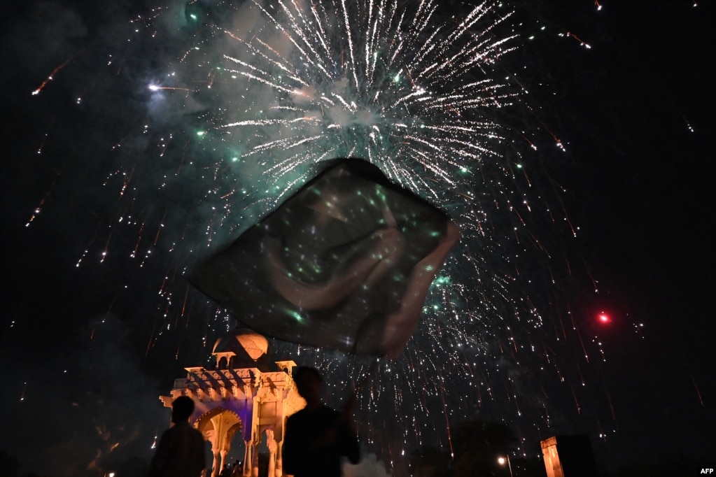 People watch fireworks explode over Islamabad as part of the Independence Day celebrations on August 14.