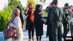 Security forces in Iran warn women to wear their hijabs properly.