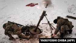 Ukrainian soldiers fire a mortar toward Russian positions in Bakhmut on February 16.