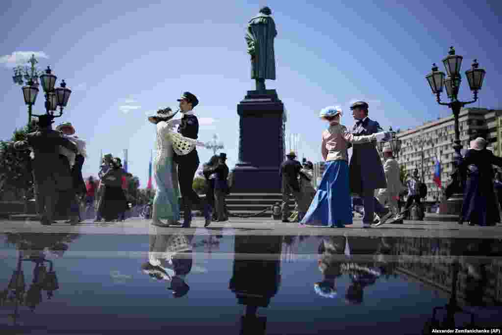 Actors wearing costumes dance at an annual historical festival, Times and Epochs, celebrating Russia Day on Pushkin Square in central Moscow on June 12.