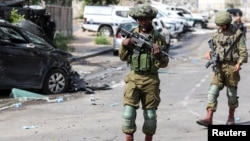 Israeli soldiers patrol in the city of Sderot near a police station that was the site of a battle following a mass incursion across the order by Hamas gunmen from the Gaza Strip on October 7. 