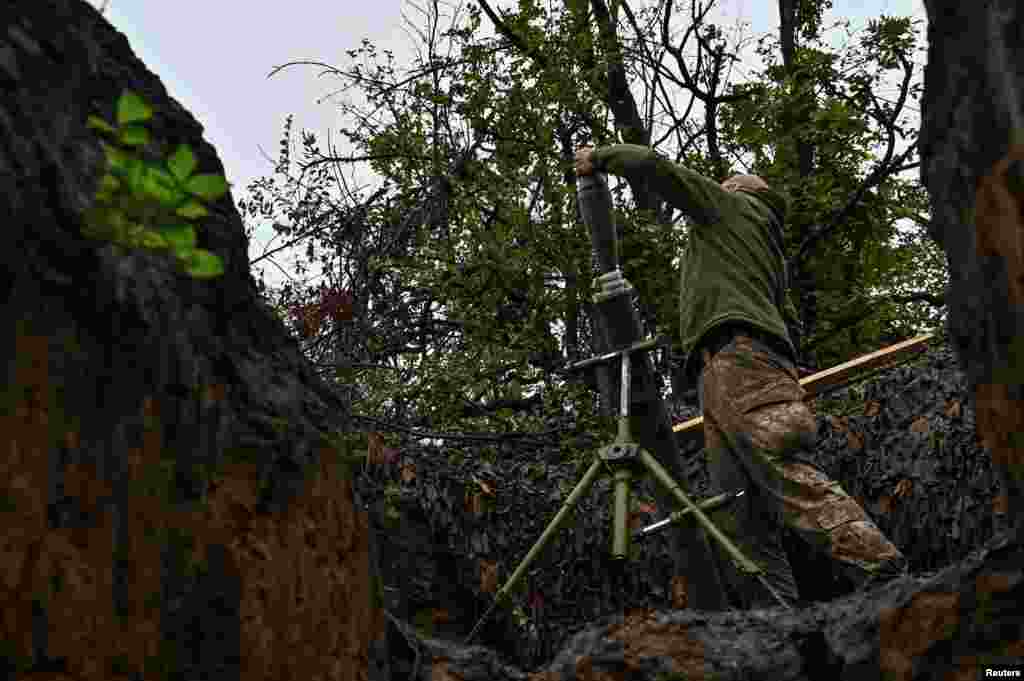 A Ukrainian soldier loads a shell into a mortar before it is fired at Russian positions. &quot;Partial success in the areas of Klishchiyivka and Andriyivka [south of Bakhmut],&quot; the General Staff&nbsp;said in its daily report&nbsp;early on October 9.