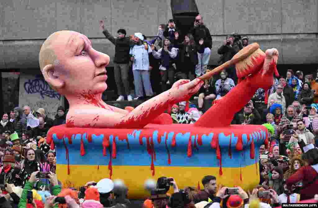 A float from a street carnival in the German city of Dusseldorf depicts Russian President Vladimir Putin washing himself in blood in a bathtub decorated with the yellow and blue colors of the Ukrainian flag.&nbsp;