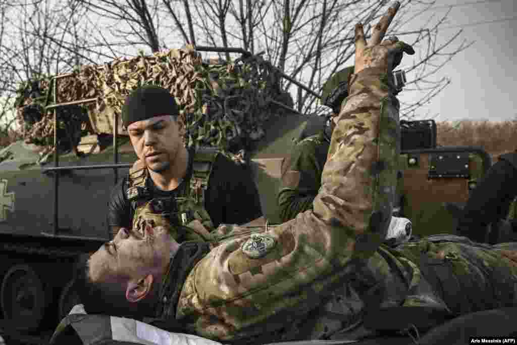 A wounded Ukrainian soldier flashes the victory sign as he is being carried away from the front. Despite heavy losses, the commander of Ukraine&#39;s ground forces,&nbsp;General Oleksandr Syrskiy, said on March 27 that defending Bakhmut was a &quot;military necessity,&quot; as he praised his forces resilience in &quot;extremely difficult conditions.&quot;