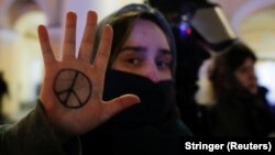 A demonstrator shows a peace symbol painted on her hand during an anti-war protest against Russia's invasion of Ukraine in St. Petersburg on March 2, 2022.