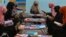 Afghan girls read at a library in Jalalabad. The Islamist group has barred girls from attending school past the sixth grade and banned women from going to university.