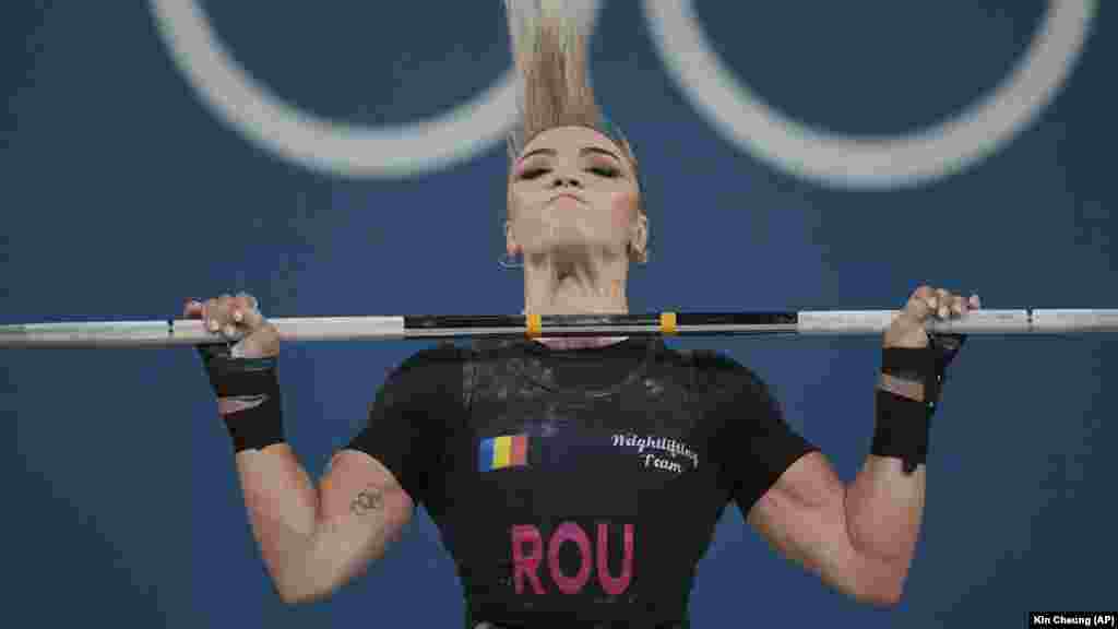 Michaela Valentina Cambei of Romania competes during the women&#39;s 49-kilogram weightlifting event to win a silver medal on August 7.