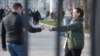 A woman in Moscow hands out leaflets calling on people to join the Russian Army.