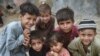 Afghan children pose for a photo at an Afghan refugee camp in Karachi on September 21.<br />
<br />
Local media <strong><a href="https://tribune.com.pk/story/2437931/pakistan-to-evict-11m-illegal-afghan-refugees" target="_self">reported</a></strong> that the caretaker government in Islamabad approved the move on September 26 to repatriate over 1.1 million Afghan nationals living illegally in the country back to Afghanistan. However, no official confirmation has been released from the interim government.&nbsp;