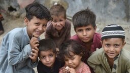 Afghan children pose for a photo at an Afghan refugee camp in Karachi on September 21.<br />
<br />
Local media <strong><a href="https://tribune.com.pk/story/2437931/pakistan-to-evict-11m-illegal-afghan-refugees" target="_self">reported</a></strong> that the caretaker government in Islamabad approved the move on September 26 to repatriate over 1.1 million Afghan nationals living illegally in the country back to Afghanistan. However, no official confirmation has been released from the interim government.&nbsp;