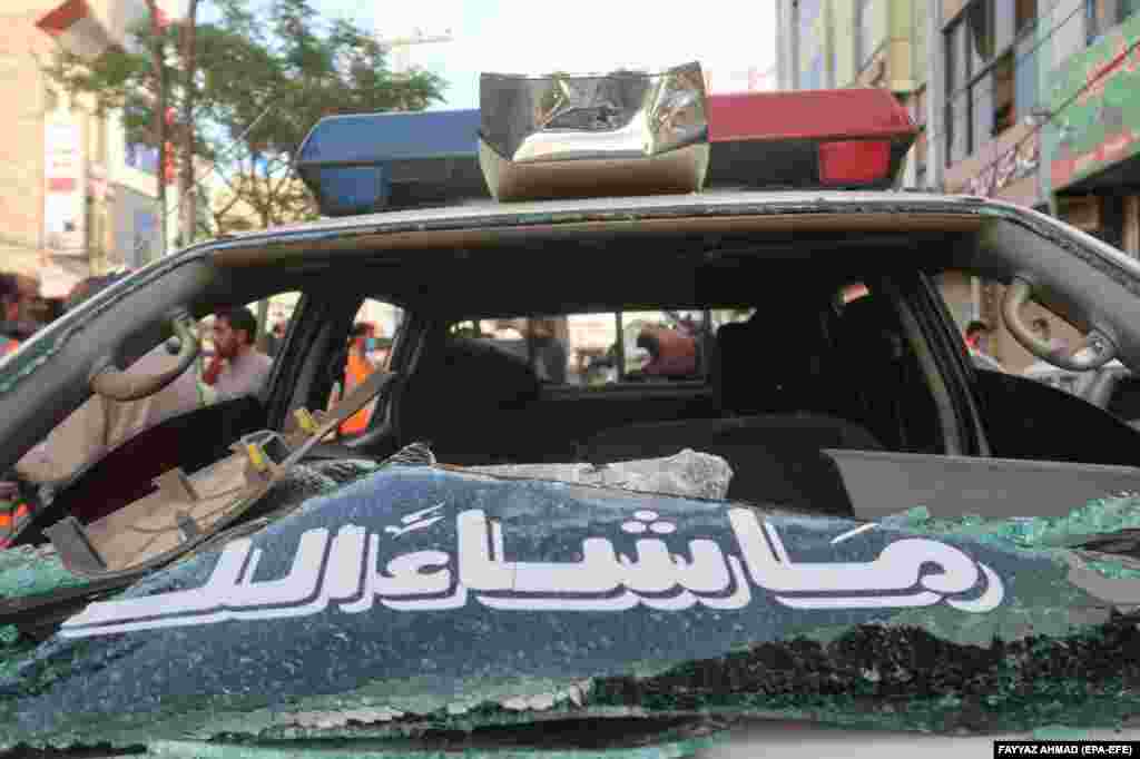 A police car lies heavily heavily damaged on the street following a bomb blast in the restive Pakistani city of Quetta.