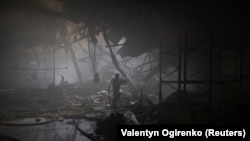 A firefighter works at the site where a printing press was hit by Russian missile strikes in Kharkiv, Ukraine, on May 23.