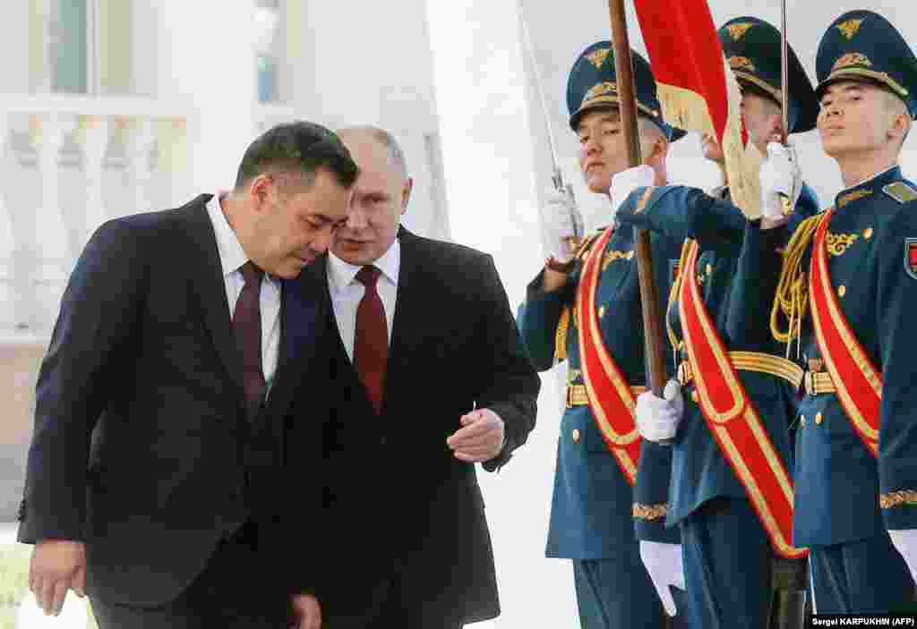 Russian President Vladimir Putin (center) and his Kyrgyz counterpart, Sadyr Japarov, attend a welcoming ceremony prior to talks in Bishkek.