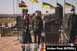 A ceremony is held in the section of Yatseve reserved for soldiers killed fighting the Russian invasion.