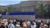 People in Sarajevo gather around a truck carrying the remains of Srebrenica victims to pay tribute on July 9.