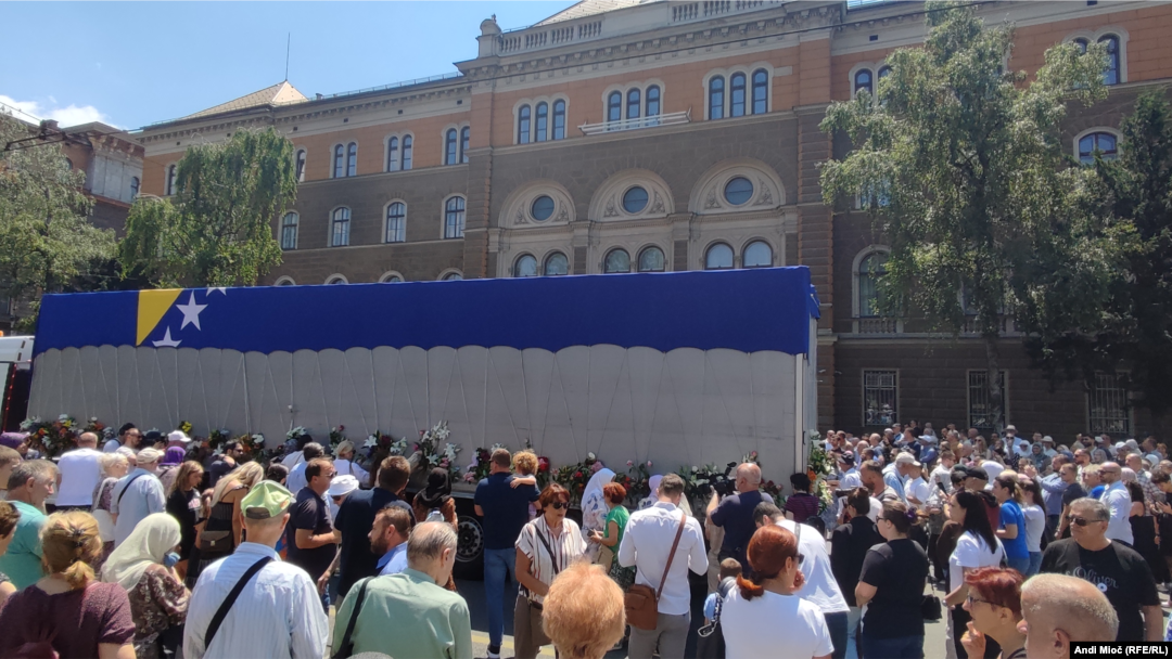 People in Sarajevo gather around a truck carrying the remains of Srebrenica victims to pay tribute on July 9.