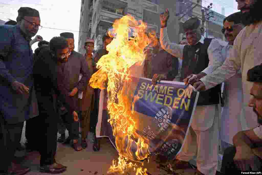 Activists of the United Muslim Forum Pakistan group burn a representation of the Swedish flag during a demonstration in Karachi, Pakistan.