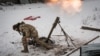 A Ukrainian soldier fires toward Russian positions in Bakhmut on February 16. Moscow&#39;s forces claim to be gaining ground as nearly round-the-clock shelling rains down on the shattered city, which Ukrainian President Volodymyr Zelenskiy has called &quot;our fortress.&quot;