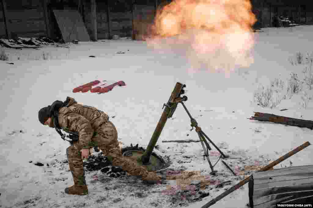 A Ukrainian soldier fires toward Russian positions in Bakhmut on February 16. Moscow&#39;s forces claim to be gaining ground as nearly round-the-clock shelling rains down on the shattered city, which Ukrainian President Volodymyr Zelenskiy has called &quot;our fortress.&quot;