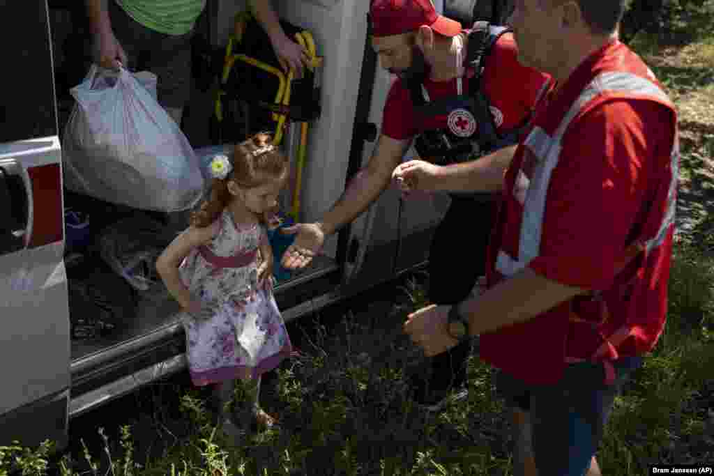 Lilia fixes her dress after she steps out of the evacuation ambulance.