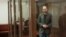 Russian opposition figure Vladimir Kara-Murza stands inside an enclosure for defendants during a court hearing in Moscow on April 17.