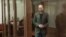 Russian opposition leader Vladimir Kara-Murza stands in the defendant's cage at the Moscow City Court on the final day of his trial, April 17, in which he was sentenced to 25 years in prison on charges of treason and spreading false information. 