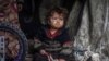 A displaced Palestinian child sitting in a tent at a camp in the city of Rafah, Gaza, in March. 