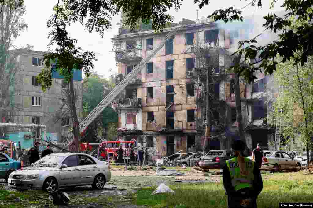 Rescuers work at the site of a residential building heavily damaged by a Russian missile strike in Kryviy Rih on June 13. At least 10 people have been confirmed dead and dozens injured, according to city Mayor Oleksandr Vilkul.