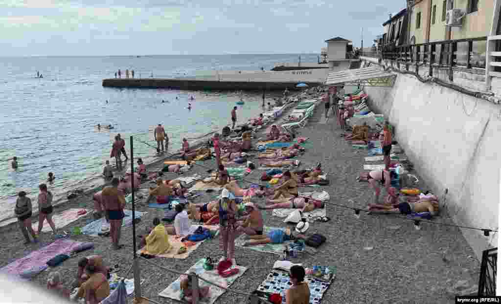 Bathers gather along the beach at Alushta undetered by recent strikes on local infrastructure. On July 6, an explosion at a gas distribution hub near Alushta sparked a massive fire, cutting off the gas supply to nearby villages. Ukraine regularly carries out strikes against Russian occupying forces along the peninsula.