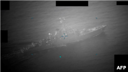 This image from the U.S. Defense Department shows what it says is a video screenshot of an Iranian naval vessel approaching the Richmond Voyager on July 5.