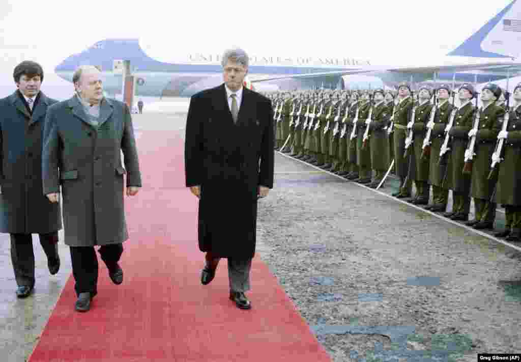 Then-U.S. President Bill Clinton walks with Stanislau Shushkevich (second from left) past a guard of honor in the opening moments of the first and only visit by a U.S. president to independent Belarus on January 15, 1994.