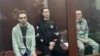 Kirill Sukhanov (left), Tamerlan Bigayev (center), and Arian Romanovsky in a Moscow courtroom (file photo)