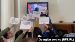 Journalists protest inside the parliament on February 20.