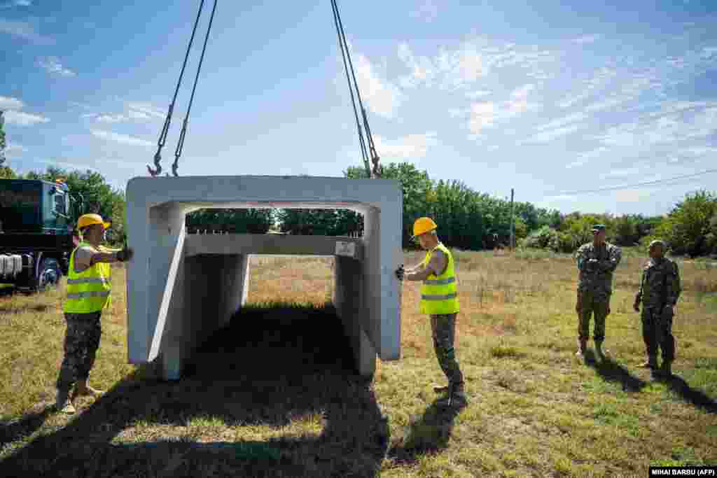 Romanian soldiers begin construction of a bomb shelter for residents of the village of Plauru, in the Danube Delta, some 300 kilometers east of Bucharest, on September 12. Romania&#39;s Defense Ministry ordered the structures to be built after drone fragments were found over the weekend.