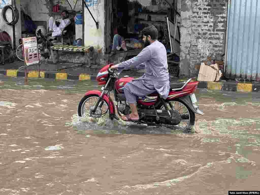 The flash flooding triggered by the latest monsoon rains have flooded streets in southern Pakistan and blocked a key highway in the north.