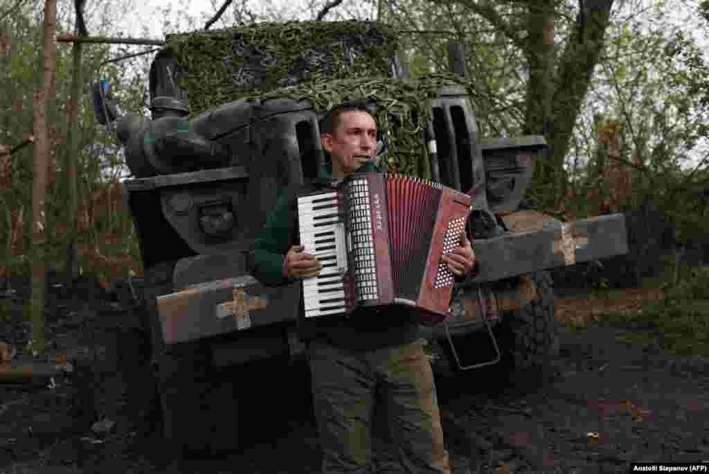 A soldier of Ukraine&#39;s 80th Separate Airborne Assault Brigade plays an accordion during a break from fighting on the front line near Bakhmut.