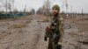 Image 1: A Ukrainian soldier in Teterivske, a village northwest of Kyiv, in March 2022<br />
<br />
Image 2: The same stretch of road in March 2024<br />
<br />
All 2022 images of&nbsp;Teterivske in this gallery were made when fighting between Russian and Ukrainian forces was ongoing in around the village in March of that year.<br />
<br />
The 2024 images were taken in late March.&nbsp;<br />
&nbsp;