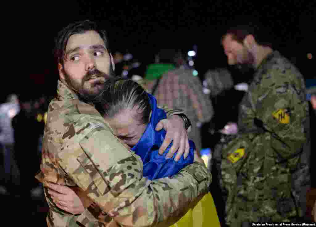 A woman greets a man in military uniform after several female Ukrainian prisoners were released from Russian captivity in Zaporizhzhya on October 17, 2022. &nbsp;