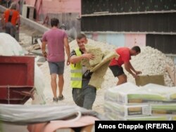 Workers at a construction site in Erd on July 12