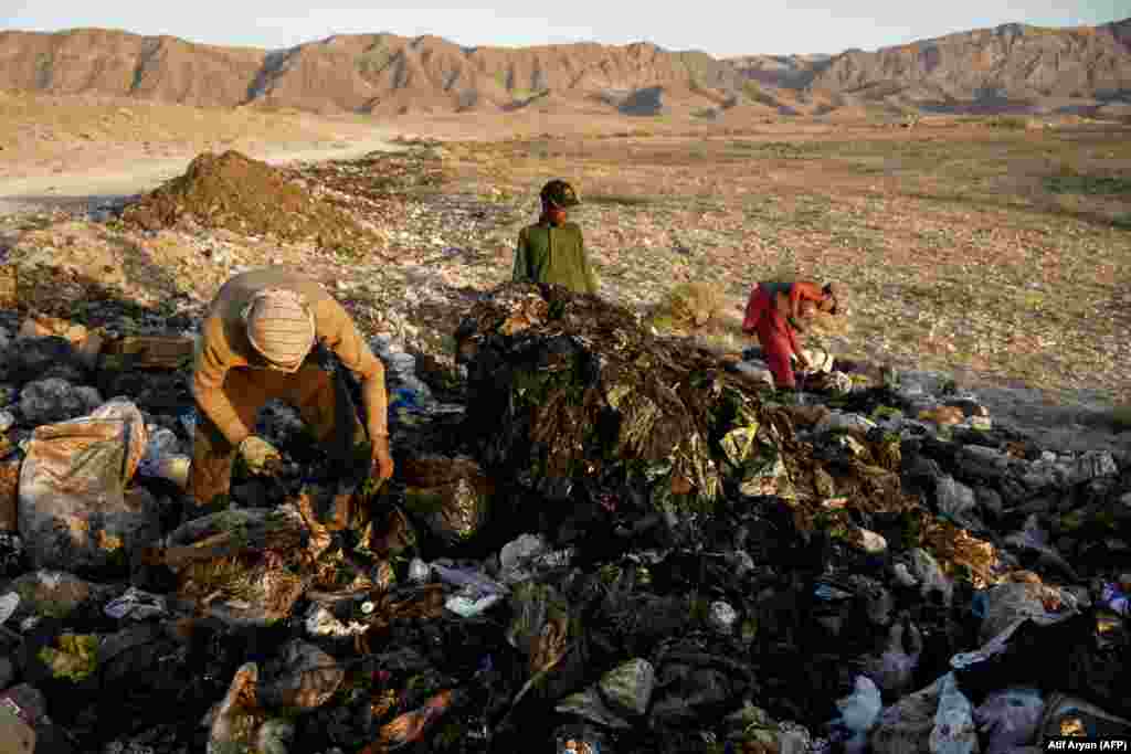 Afghan boys search for recyclable materials at a garbage dump on the outskirts of Mazar-i- Sharif.