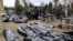 Bodies are lined up for identification by forensic personnel and police officers in the cemetery in Bucha, north of Kyiv, on April 6, 2022, after Russian troops had withdrawn from around Ukraine's capital.