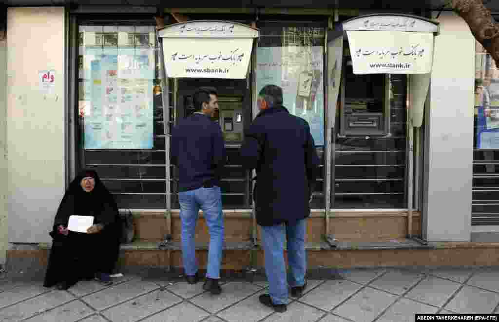 Iranians use an ATM machine on a street in downtown Tehran. Iran is facing an economic crisis after its currency dropped to its lowest value against the U.S. dollar and other foreign currencies last week, following sanctions imposed by the United States and the EU.