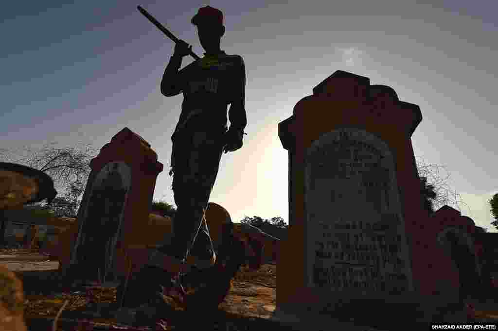 A worker participates in the restoration work of the largest Jewish cemetery in Karachi, Pakistan.