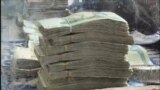 GRAB- Afghans Defy Taliban Ban On Using Foreign Currencies 