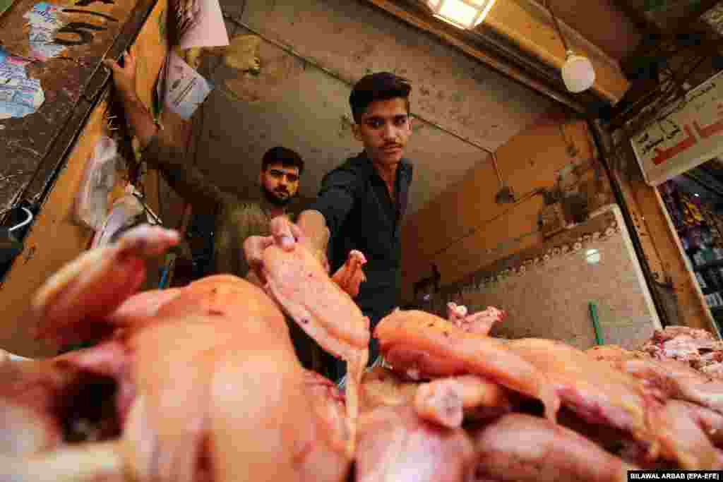 A vendor sells meat at a shop in Peshawar, Pakistan.